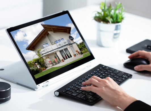 Someone using a laptop to look at a property