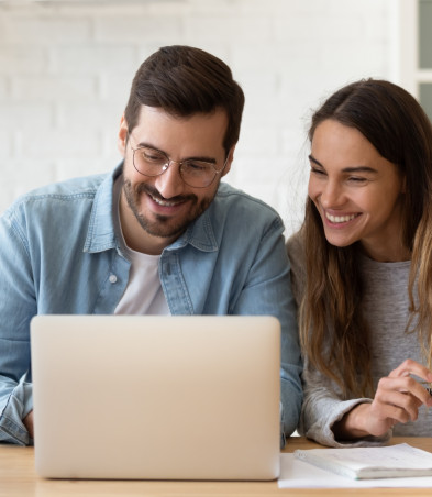 A couple looking at a laptop.