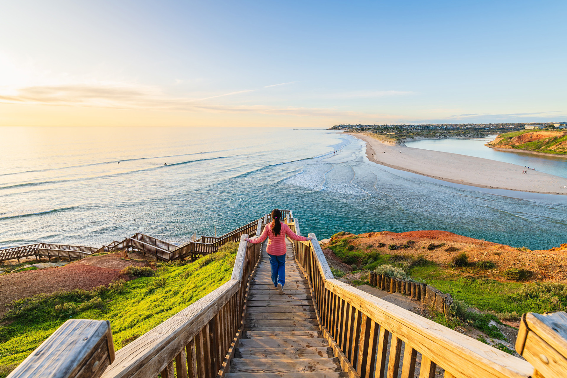 Woman walkind down stairs to beach